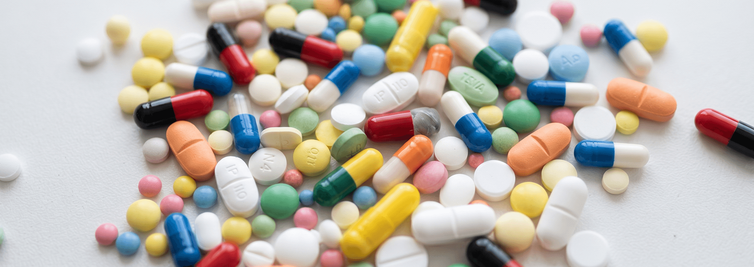Medicines scattered on white surface